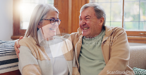 Image of Senior couple, happiness and retired while laughing, talking and smile, couch and touch. Retirement, old age home and elderly in living room, couch and bonding together for quality time, hug or care