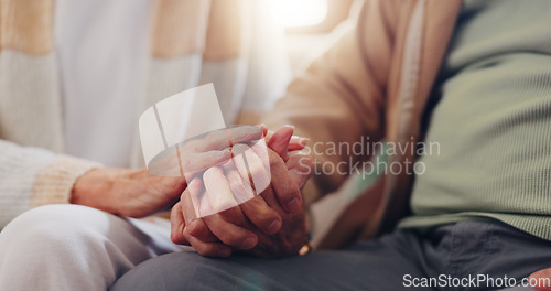 Image of Holding hands, empathy and an elderly couple closeup in their home for love, support or trust in retirement. Hope, healing or sympathy with senior people on a sofa in the living room of their home