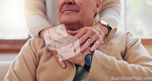 Image of Hands, empathy and a senior couple closeup in their home for love, support or trust during retirement. Hope, healing and sympathy with elderly people on a sofa in the living room of their home