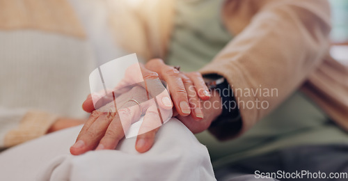 Image of Hands, support and a senior couple closeup in their home for love, sympathy or trust during retirement. Hope, healing and empathy with elderly people on a sofa in the living room of their home