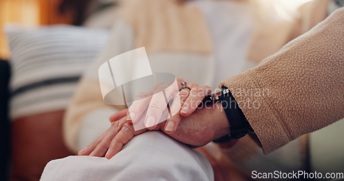 Image of Hands, support and a senior couple closeup in their home for love, sympathy or trust during retirement. Hope, healing and empathy with elderly people on a sofa in the living room of their home