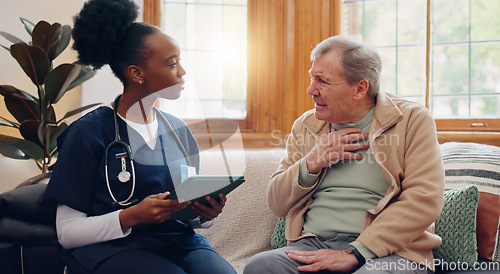 Image of Healthcare, tablet and a senior man with a caregiver during a home visit for medical checkup in retirement. Technology, medicine and appointment with a nurse talking to an elderly patient on the sofa