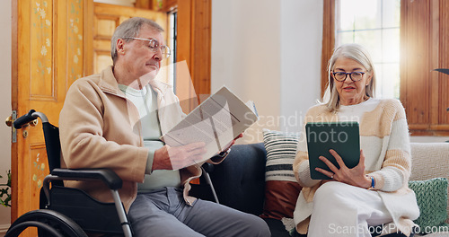 Image of Elderly couple and care, retirement house and wheelchair in nursing home with people reading books, news or tablet with hobbies. Retirement and relax in house living room with notebook