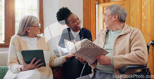 Image of Elderly care, nurse and talking in home with people reading books, news or tablet with discussion of support. Retirement, caregiver and relax in conversation or house living room with notebook