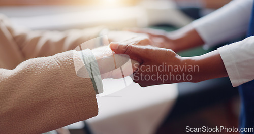 Image of Nurse holding hands with a senior patient for empathy, trust or support of help, advice or healthcare. Consulting, elderly person or medical therapy with doctor for hope, consultation or depression