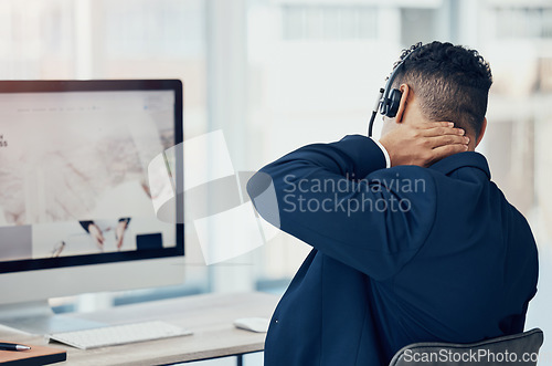 Image of Neck pain, call center worker and tired employee man working in office chair the desk of online telemarketing sales business. CRM consultant, workplace injury and pinched nerve from company computer