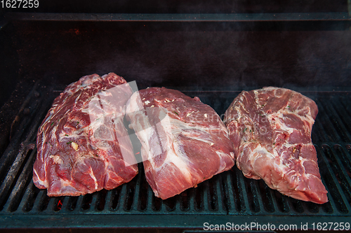 Image of Pork meat steaks on the grill