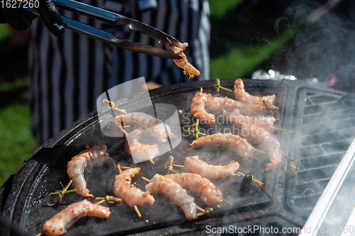 Image of A professional cook prepares shrimps