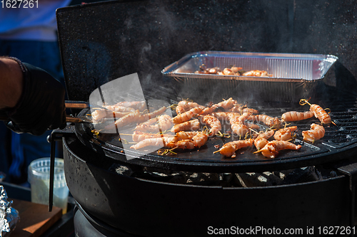 Image of A professional cook prepares shrimps