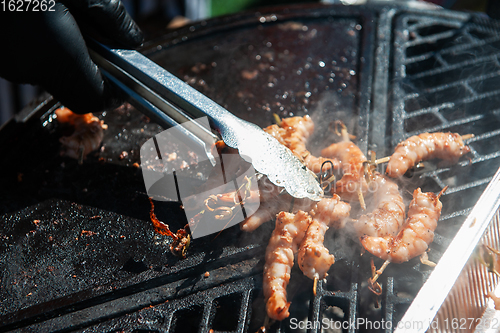 Image of A professional cook prepares shrimps