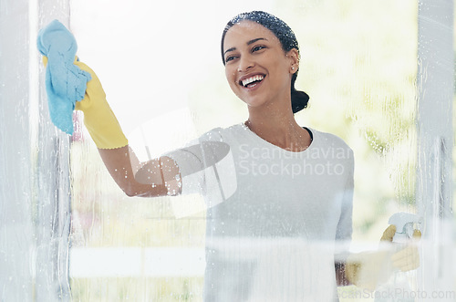 Image of Cleaning, glass and shower door with woman in bathroom for hygiene, bacteria and sanitize. Smile, service and washing with girl and cleaner product at home for housekeeping, germs and disinfection