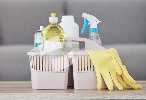 Image of Cleaning container, spray bottle or rubber gloves on table in house, home or hotel living room for bacteria protection cleaner service. Zoom, housekeeping or healthcare hygiene product in maintenance