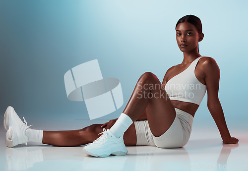 Image of Fitness, woman and portrait in studio for health, exercise and body goals against a blue background mockup. Floor, workout and indian girl model with strong, athletic mindset and sports aesthetic