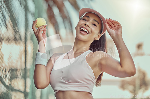 Image of Happy, woman and tennis ball with smile for sports, exercise or fun workout in the summer outdoors. Portrait of female in sport fitness smiling for healthy cardio, tennis or training at the court