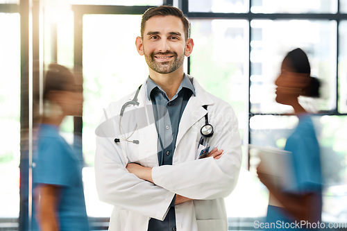 Image of Doctor, hospital and medical insurance with stethoscope and healthcare worker happy about career choice, service or care. Portrait of male medicine or cardiology expert with busy staff for emergency