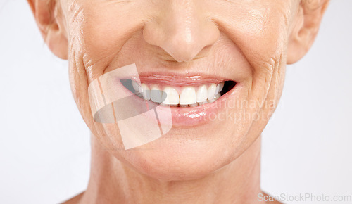 Image of Teeth, mouth and smile of a senior woman with dental cleaning against a grey studio background. Dentist, wellness and elderly model with healthcare and happy with results from veneers for beauty