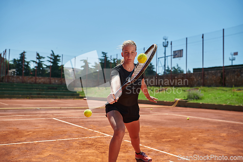 Image of A young girl showing professional tennis skills in a competitive match on a sunny day, surrounded by the modern aesthetics of a tennis court.