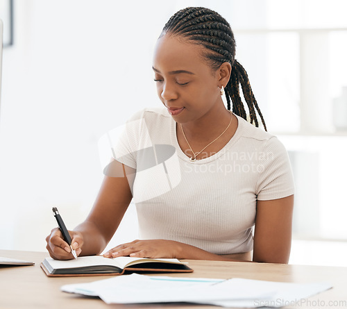 Image of Notebook, working and black woman writing notes in office, sitting at desk. Ideas, vision and businesswoman with pen in hand to write, jot and taking notes in business meeting in book or work diary