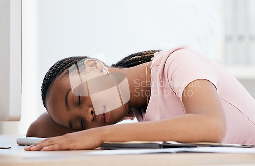 Image of Burnout, sleep and black woman tired from stress, anxiety and problem at a desk in an office at work. Young African corporate worker sleeping at a table exhausted with depression or mental health