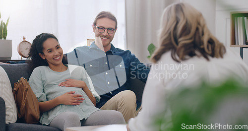 Image of Pregnant, happy and couple in counseling with a psychologist consulting, listening and helping. Communication, pregnancy and healthy woman talking to a marriage therapist with partner for support