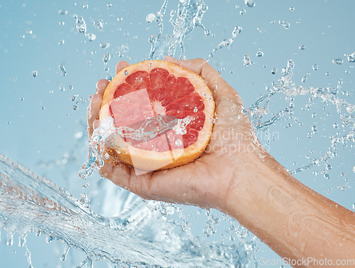 Image of Grapefruit, fruit and water for health of body and skin with natural diet to lose weight or skincare with dermatology food. Hand holding vitamin c snack for a healthy lifestyle or female orgasm