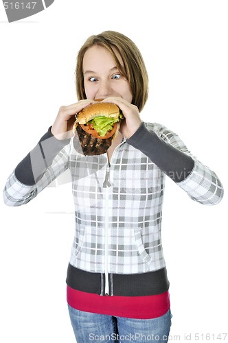 Image of Teenage girl eating big hamburger