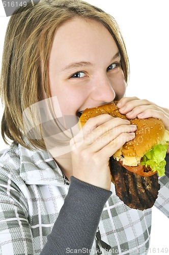 Image of Teenage girl holding big hamburger