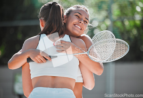 Image of Badminton, happy and sports friends hug together for bond, love and care with smile on game break. Exercise, workout and happiness in women friendship with embrace on outdoor summer court.