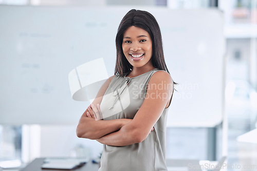 Image of Marketing manager, leadership and smile of a black woman standing with arms crossed in a startup business for motivation, innovation and success. Pride, happy and professional entrepreneur in office