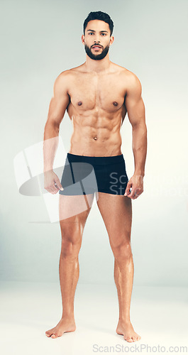 Image of Portrait, bodybuilder and healthy man for fitness, wellness or workout being toned for flex with studio background. Muscular male, health or athlete muscle with endurance, power or body care exercise