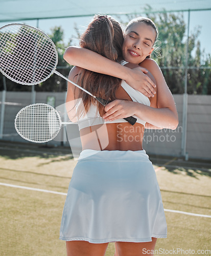 Image of Women hug after friendly badminton game, court competition and congratulations friends win together. Social sports practice, celebrate healthy support and happy athlete smile in summer fitness