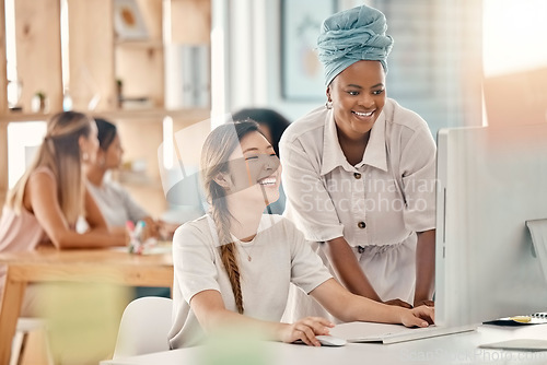 Image of Diversity, help or training at computer in web design company office brainstorming idea with smile. Asian, black woman and interracial webdesign employees working on ux project in workplace.