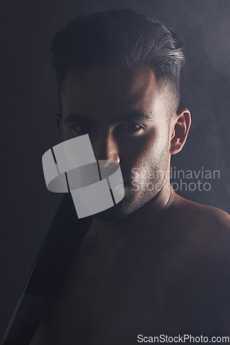 Image of Fitness, baseball bat and portrait of man in studio background in dark creative art shoot in India. Beauty, danger and professional male model, topless Indian man and serious face on black background