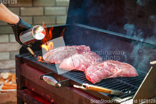 Image of Pork meat steaks on the grill