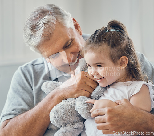 Image of Grandfather play with grandchild girl in living room, lounge and family home with teddy bear toys, fun and happiness in Australia. Happy senior grandparent man relax with young kids together in house