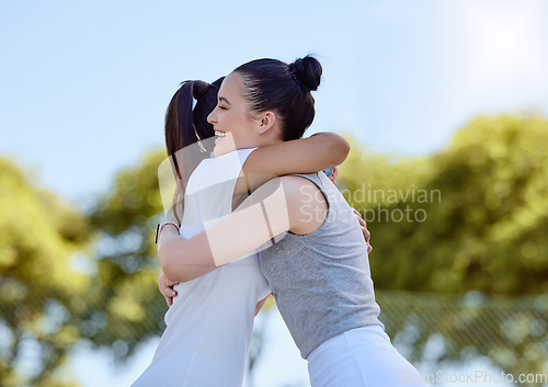 Image of Women, friends and success hug at park outdoors for congratulations or celebration of winning, goals or targets. Hugging, sports fitness or thank you of female training with tennis personal trainer