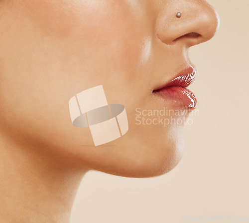 Image of Mouth, lipstick and woman in studio for beauty, skincare and dermatology wellness. Zoom face of a young model with lips care, gloss and cosmetics makeup for healthy glow, botox or plastic surgery