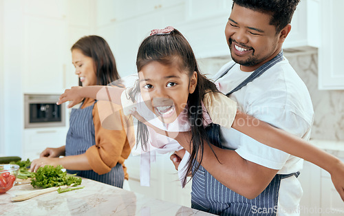 Image of Mother, father and child play while cooking in the kitchen bonding, laughing and having fun happy family home, Smile, mama and dad enjoy playing with girl or kid in a healthy dinner meal preparation