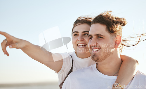 Image of Vacation, view and travel with a normal couple sightseeing while on holiday together during summer. Sky, love and traveling with a real man and woman pointing while outside on a weekend getaway
