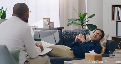 Image of Black man, psychologist or patient in counseling clinic in mental health, anxiety or depression rehabilitation on medical insurance. Talking, consulting or psychology counselling sofa in help therapy