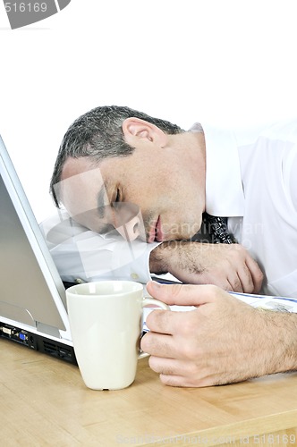 Image of Businessman asleep at his desk on white background