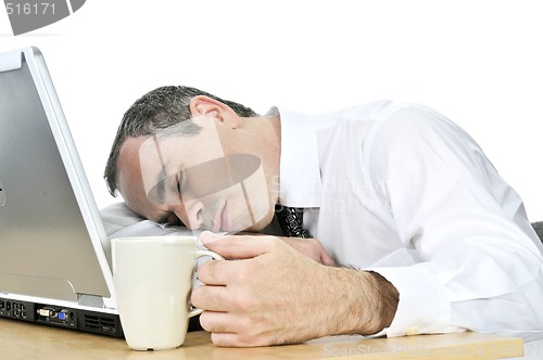Image of Businessman asleep at his desk on white background