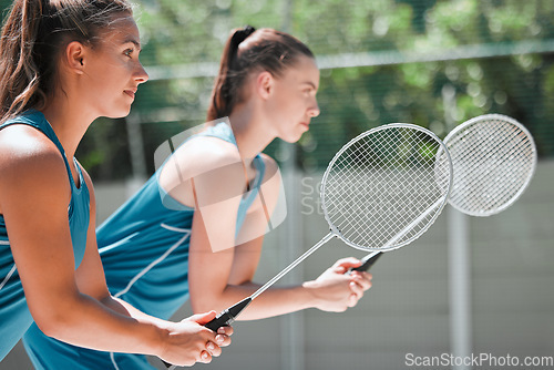 Image of Teamwork, sports and badminton with women on court for training, workout and exercise together. Games, match and competition with girl athlete ready for cardio, health and fitness endurance in summer