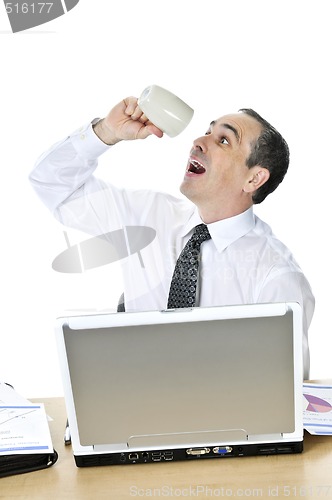 Image of Overworked businessman at his desk on white background
