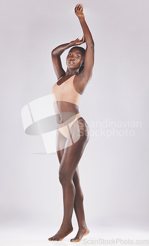 Image of Beauty, black woman and wellness in studio for health, body and grooming, hygiene and treatment on grey background. Portrait, skincare and girl model pose, sexy and desire, lingerie and full body