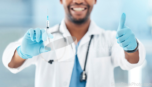 Image of Doctor, vaccine syringe and thumbs up at work in hospital, clinic or office in healthcare. Medic, man and professional in medical worker show hand sign working in health, medicine or community safety