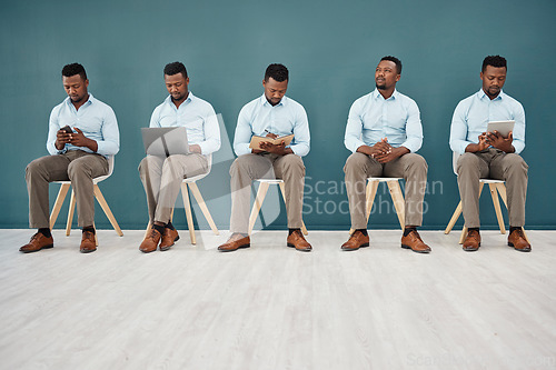 Image of Interview, hiring and waiting with a black man in business sitting in line for a meeting with human resources. HR, recruitment and opportunity with a male employee on the search for a new job