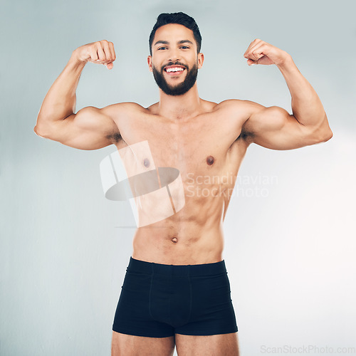 Image of Fitness, biceps and man flexing arms on studio background with muscle growth and development in training exercise. Workout, gym and happy healthy bodybuilder from Mexico, muscles, health and wellness