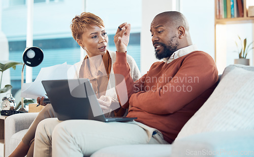 Image of Laptop, black couple with stress for financial audit, tax debt or house mortgage in living room. Bad finance, tech or black woman and man or worried with savings documents or bill payment paper