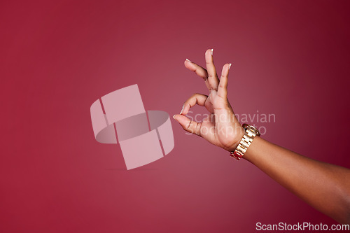 Image of Hand, woman and okay sign at a studio in support of decision, approve and yes closeup on red background mockup. Model hands and ok gesture by girl showing signal for approval, agree and continue